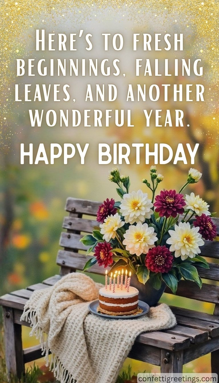 fall birthday greeting - fall flowers on a rustic bench with a birthday cake with a fall background